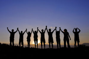 silhouettes of people on mountains