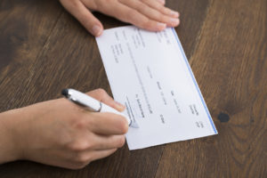 Person Hands Signing Cheque