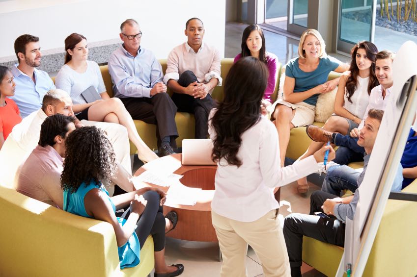 Businesswoman Making Presentation To Office Colleagues